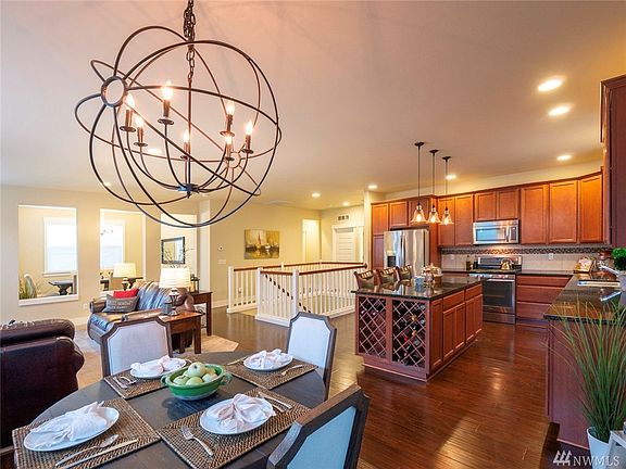 Stunning Open Concept Living! Incredible lighting upgrades from Restoration Hardware, 8"baseboards, 9 ft ceilings, laminate flooring throughout, and plenty of room for ultimate entertaining!