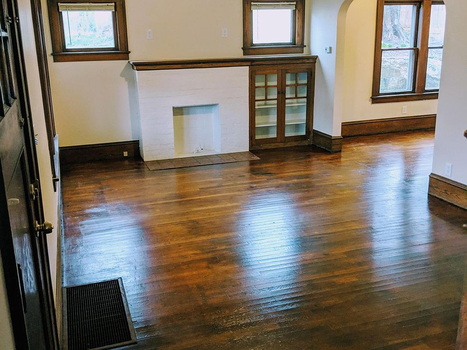 Living room with beautiful built-ins, opens to dining room.