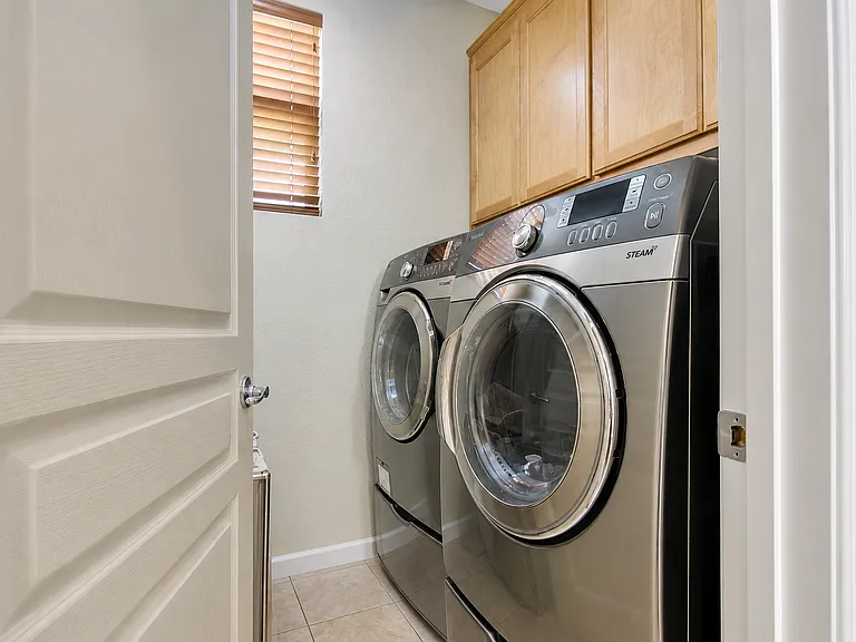 Laundry room with additional storage.