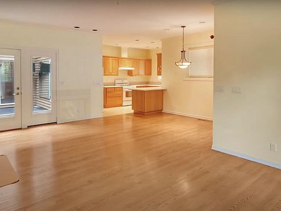 Living room with kitchen. Blinds on glass doors will offer privacy from the main house.