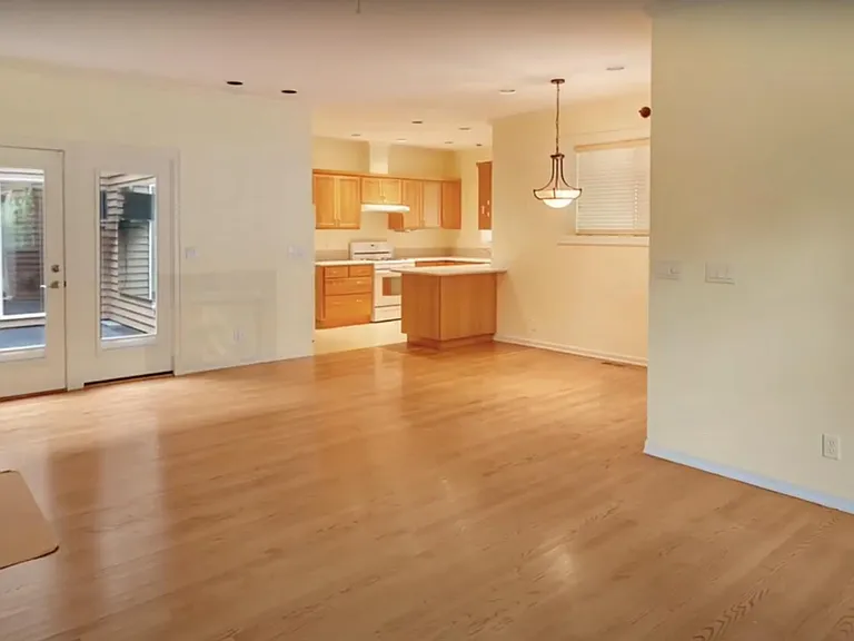 Living room with kitchen. Blinds on glass doors will offer privacy from the main house.