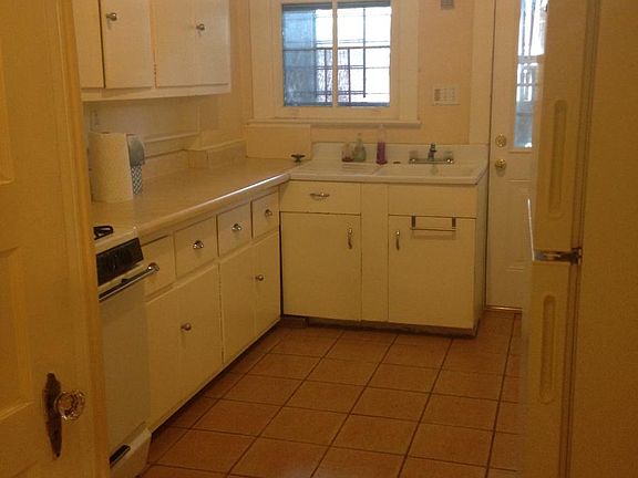 Kitchen with Terracota tiles leading to back porch and yard