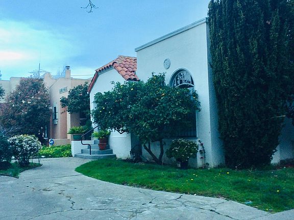 Approach to court from street note lemon tree. 
Automatic sprinkler system