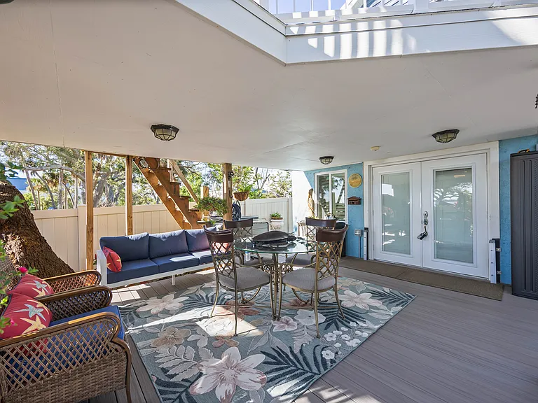 OWNERS ENTRY FRENCH DOORS WITH COVERED DECKING AND SEATING AREAS. ALL NEW MIAMI/DADE IMPACT DOORS AND WINDOWS ON ENTIRE BUILDING WITH NEW 2" STANDING SEAM METAL ROOF.