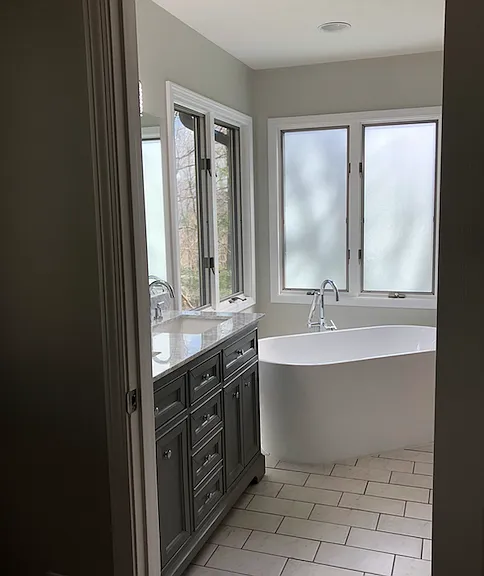 Primary bathroom with soaker tub, shower and linen closet