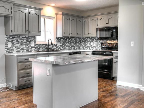 Kitchen features center island/breakfast bar