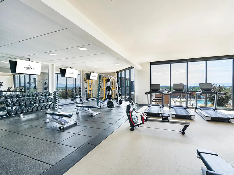 Expansive fitness center with strength training, cardio, and stunning mountain views to match your motivation.