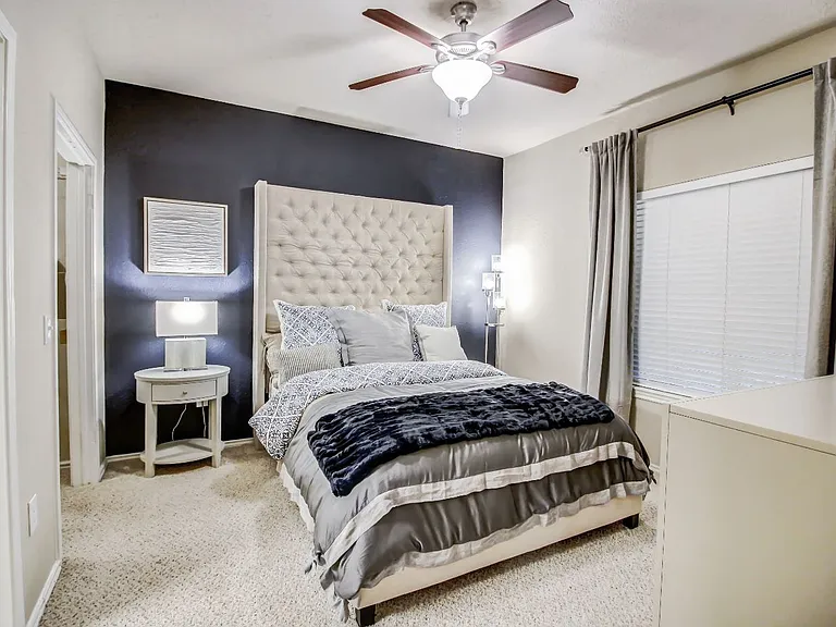 Spacious bedrooms with large windows for natural lighting, ceiling fan and plush carpet