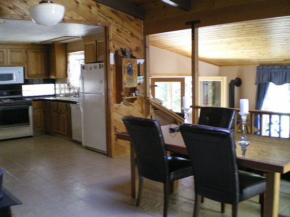From dining area, kitchen on left, looking to french doors onto covered patio