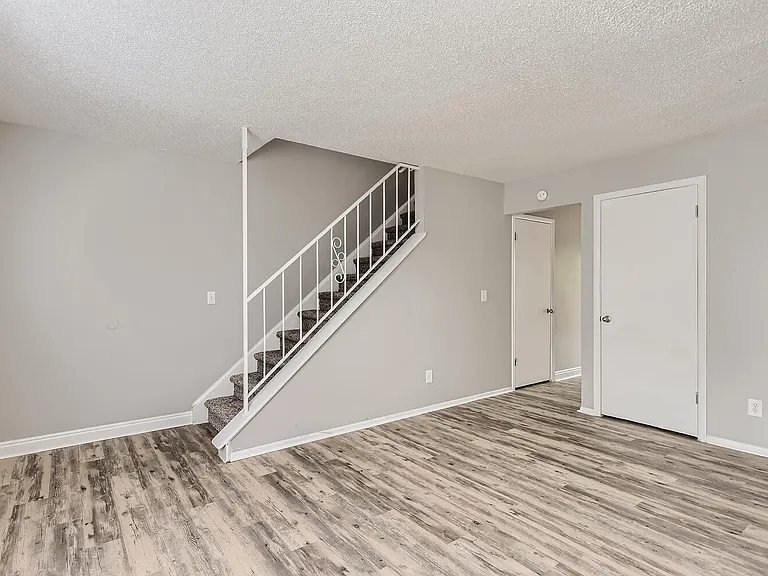 A living Room and staircase at Alder Square Rental Townhomes