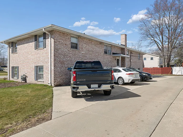 BACK AND SIDE OF BUILDING AND PARKING AREA FROM 3RD STREET