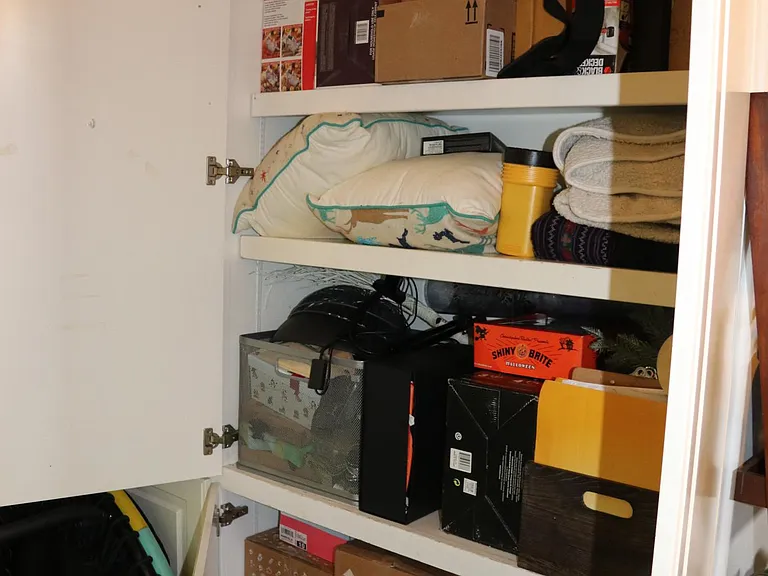 One of a number of large shelving units in the back of the sunroom which provides a lot of storage space