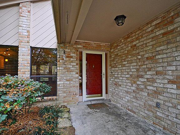 Stylish red front door welcoming you home.