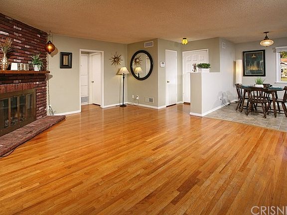 The spacious living room is bathed in natural ligh