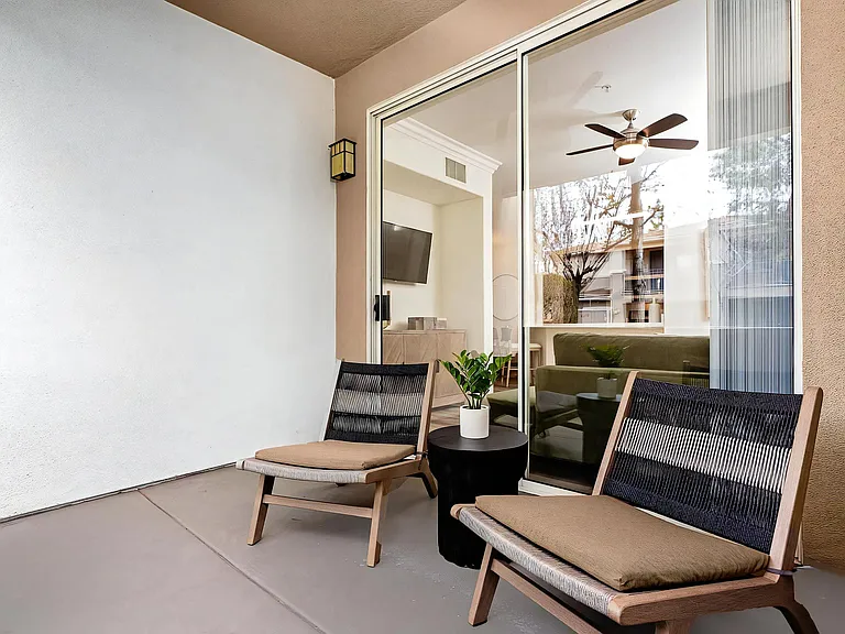 Secluded Outdoor Patio with Two Lounge Chairs and Sliding Glass Door Access