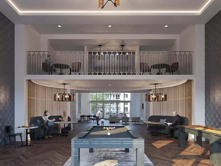 Two-story clubroom featuring a catering kitchen, game room and a TV room with oversized soft seating
