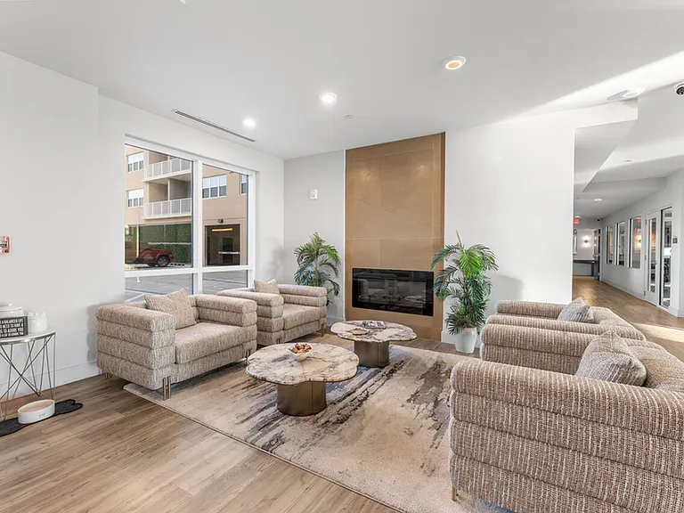 Inviting lounge area with cozy seating, stylish marble tables, and a modern fireplace, perfect for relaxation and entertaining.
