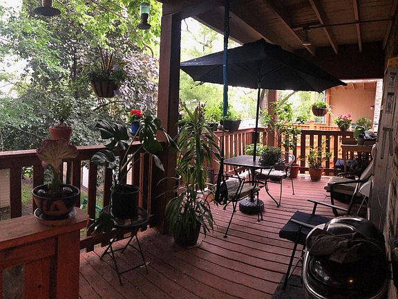 Deck with entrances from both kitchen and BR2 overlooks yard and garage