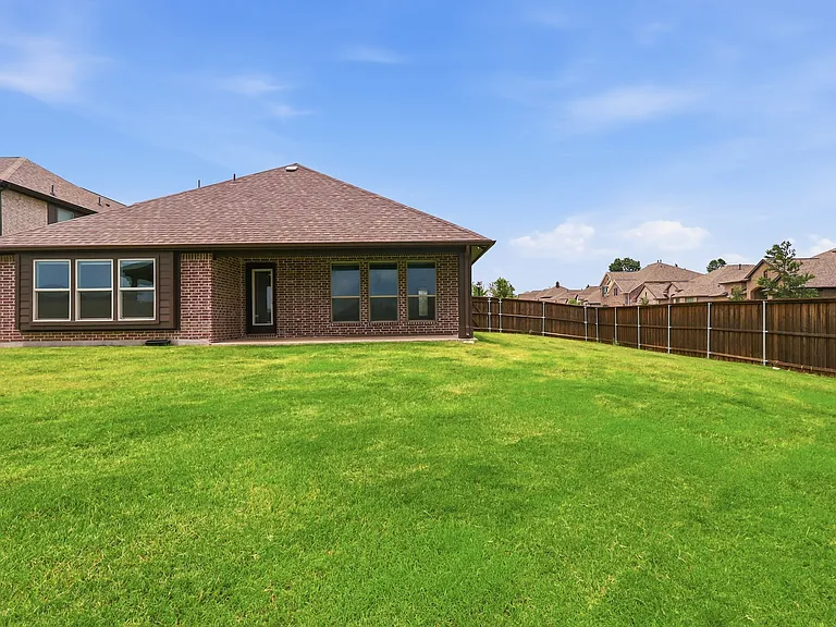 Expansive grassy yard featuring a wood privacy fence