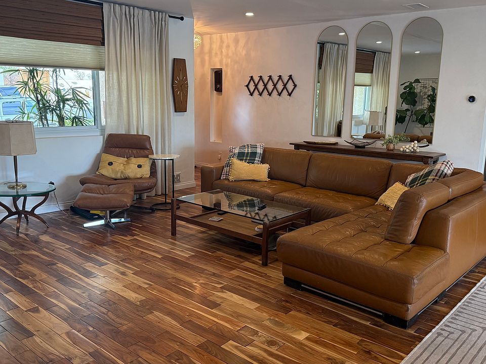 Living room area. Italian leather chaise sofa, swivel chair and footrest.