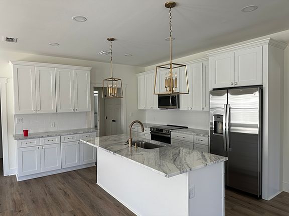 White, granite countertops, walk in pantry.