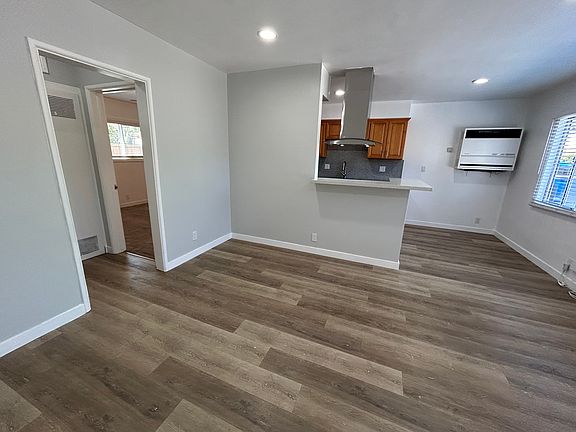 Living room, kitchen in back, entrance to bedroom and bathroom on the left.
