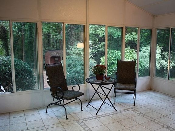 Enjoy the sunroom with ceiling fan & tile flooring.