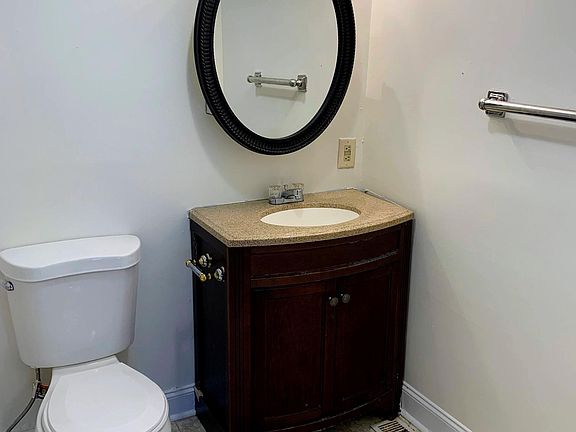 Bathroom has new toilet and vanity. The shower is to the left.