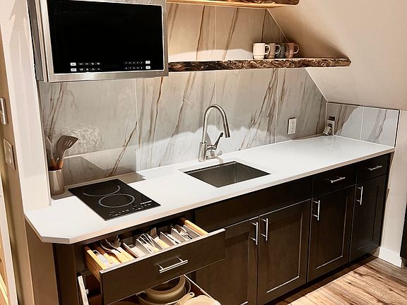 Fully stocked kitchen with brand new appliances, utensils, and cooking supplies.