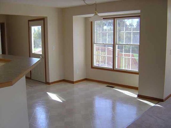 Bar and dining area off-kitchen has view of the deck and back yard.