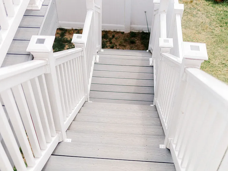 Looking down stairs from 2nd floor back deck to backyard