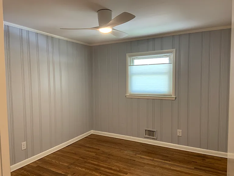 First bedroom with a closet and remote control fan and light.