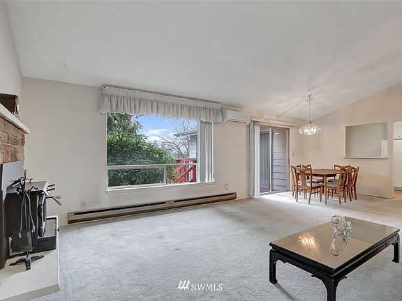 Well-lit living room & dining room via the big picture window and sliding doors.