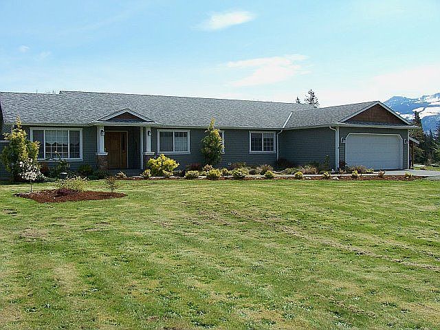 Front of house from near road, expansive front yard.