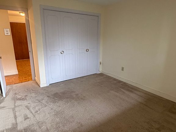 Bedroom with double closet and new carpeting