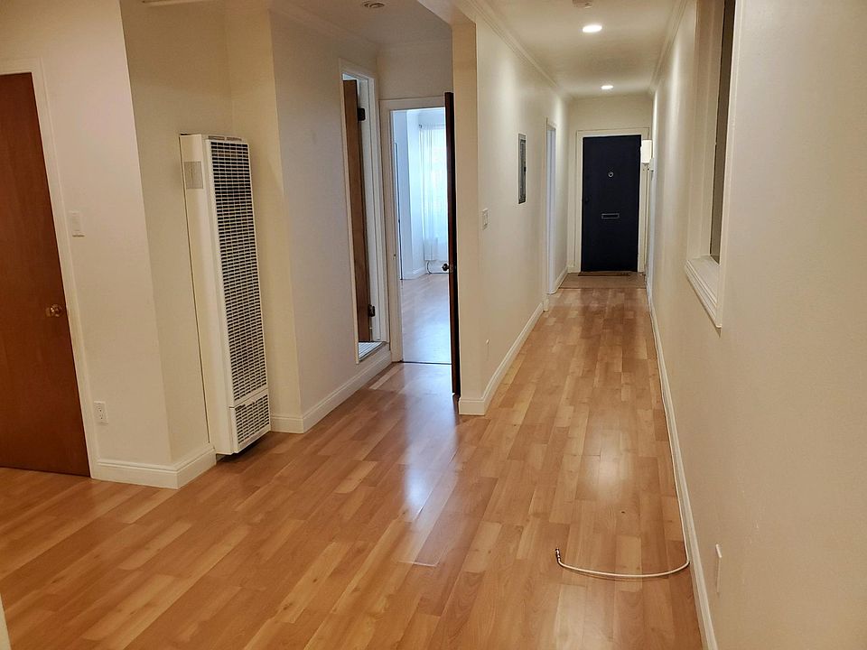 Front door on the right; Wall heater on left