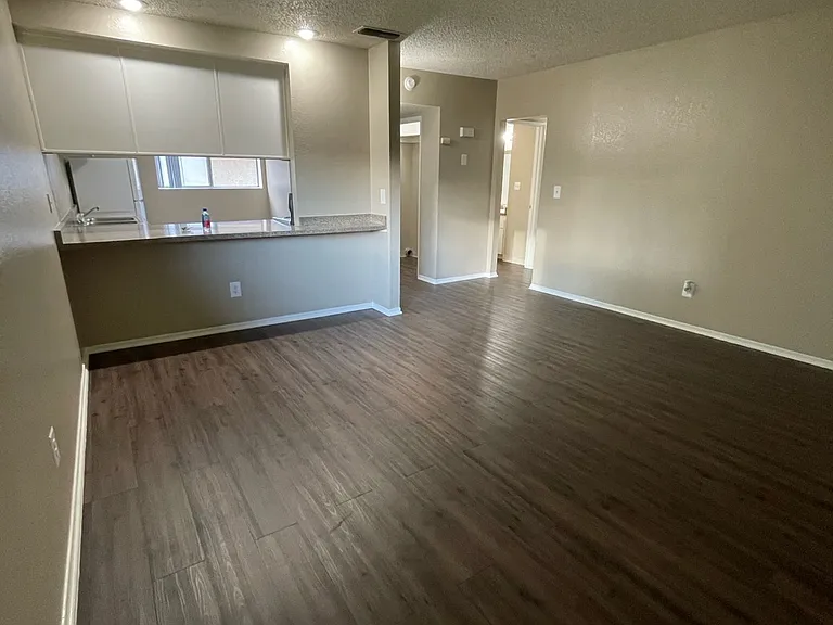 Living room area, looking into kitchen for gatherings. Perfect for some bar stools and a open setting for a family function.