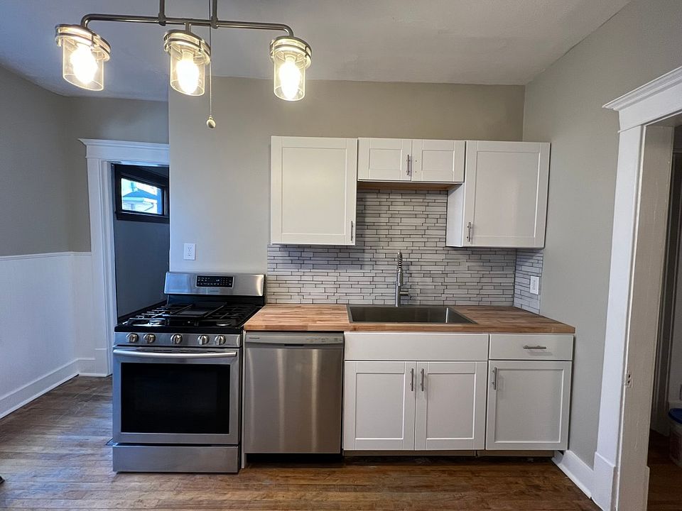 Off the Dining Room is the remodeled Kitchen. New cabinets, appliances, lighting, glass backsplash, butcher block counters, stainless sink, gas stove.