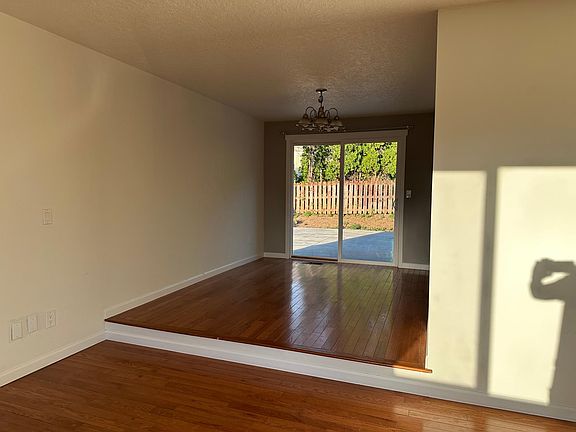View of living room to dining room; with backyard beyond.
