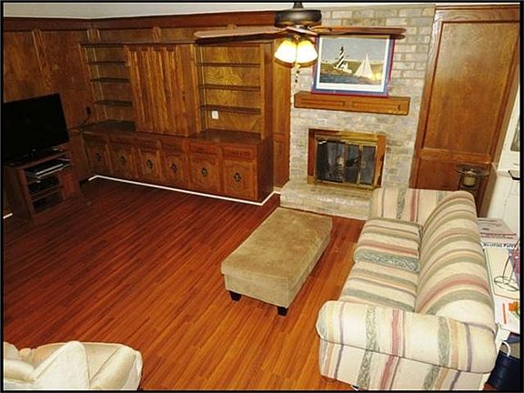ANOTHER LOOK AT THE FAMILY ROOM SHOWING THE WOOD BURNING FIREPLACE.