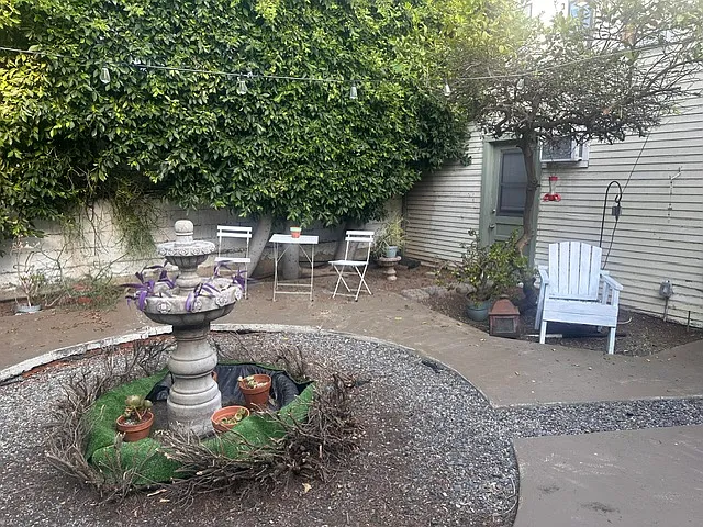 Large private backyard with outdoor seating and fountain
