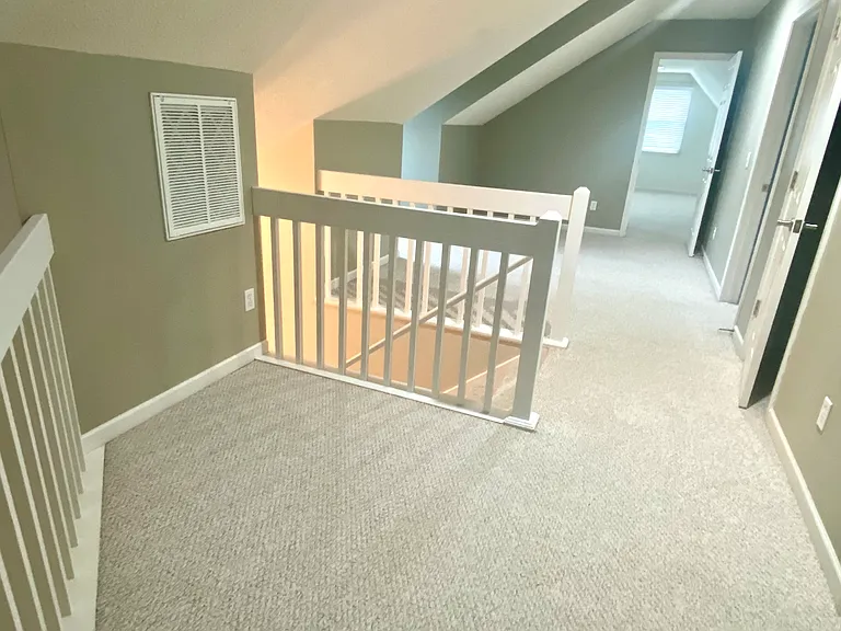 unfurnished loft looking toward largest upstairs bedroom