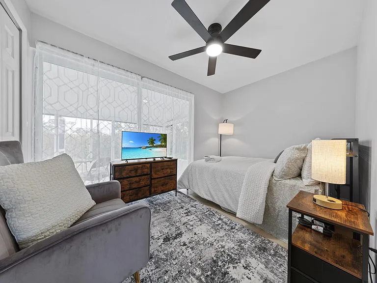 Full bedroom with ceiling fan, TV, area rug, accent chair move in tonight.