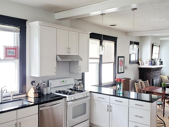 Stainless steel farmhouse sink and dishwasher, gas stove, and ample storage