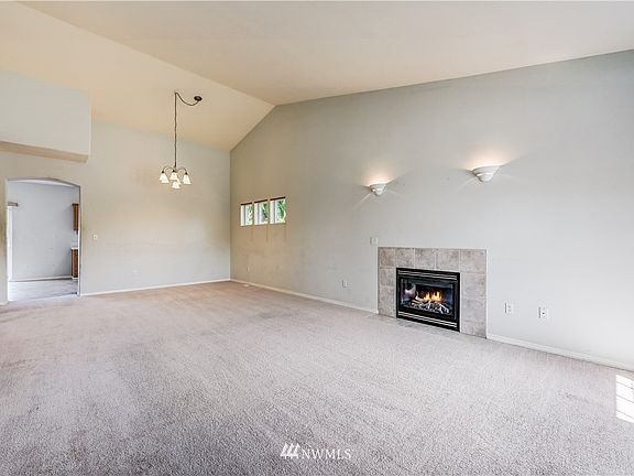 Amazing space!  Huge living room, spacious dining room...  Or... OR... Make it one massive LIVING room... 
Because you COULD use the family room, for your dining area... Love flexible living spaces... Sometimes it's fun to 'shake things up a little' and be different... Lives extremely large either way.  One of two gas fireplaces. Nice architectural details enhance the space; bay window, interesting ceiling lines, arches and more.  Loads of natural light... Bright, warm, cozy and inviting.  Nice lighting features as well.  Fabulous design, great wall and window space... Nice balance! Lives well!