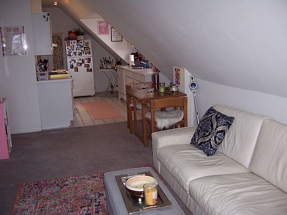LR view to kitchen. Full size couch to wall on right.