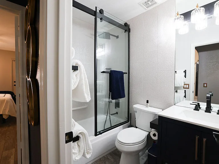Main hall bath with tub, rain shower head, hand held shower, cabinet, medicine cabinet, 10x magnifying mirror, towels for 2, safety grab bars