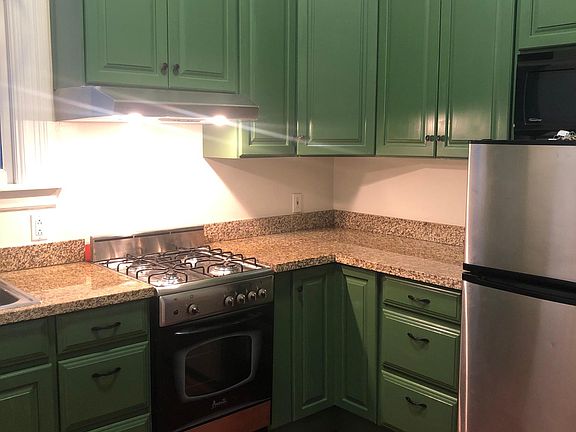 Kitchen, with newly refinished hardwood floors and newly painted cabinets