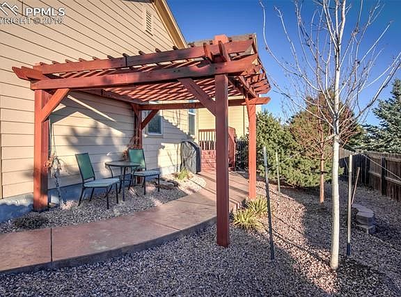 Stamped concrete walk way from the deck all around the side of the home to the front driveway.