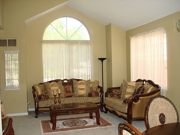Formal living room with vaulted ceilings